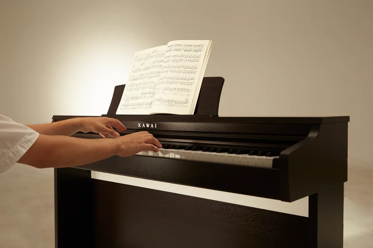 Hands playing the Kawai KDP120