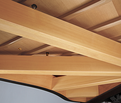 All-spruce beams beneath a Shigeru Kawai grand piano