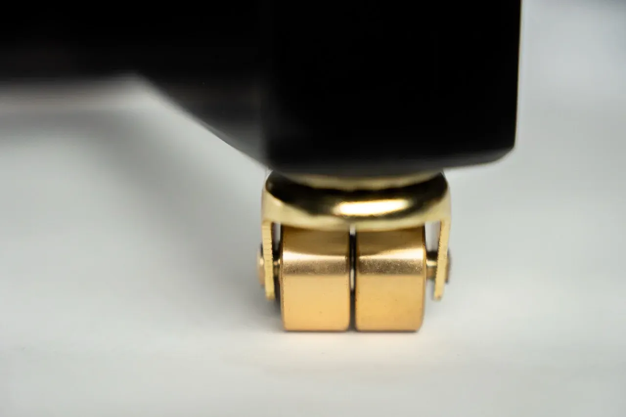 Polished brass caster on the Kawai K-500