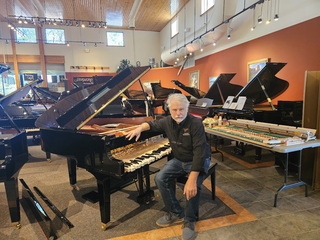 Dr. Larry McDonald in a piano showroom