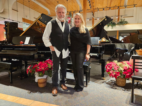 Hartland Piano owners posing by grand pianos