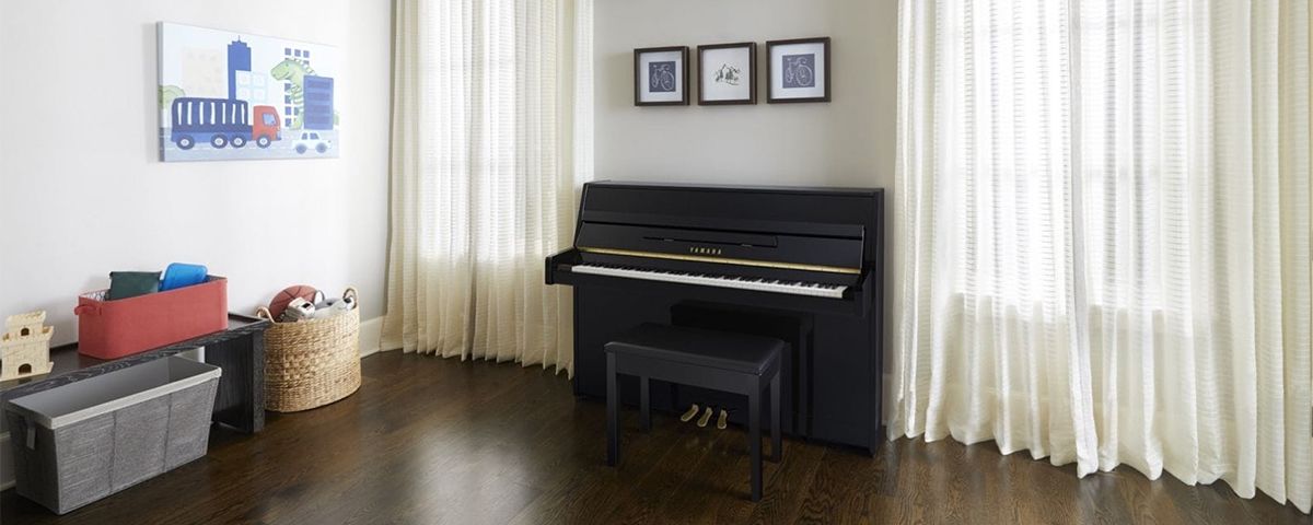 Yamaha b Series upright piano and bench in a bright living room.