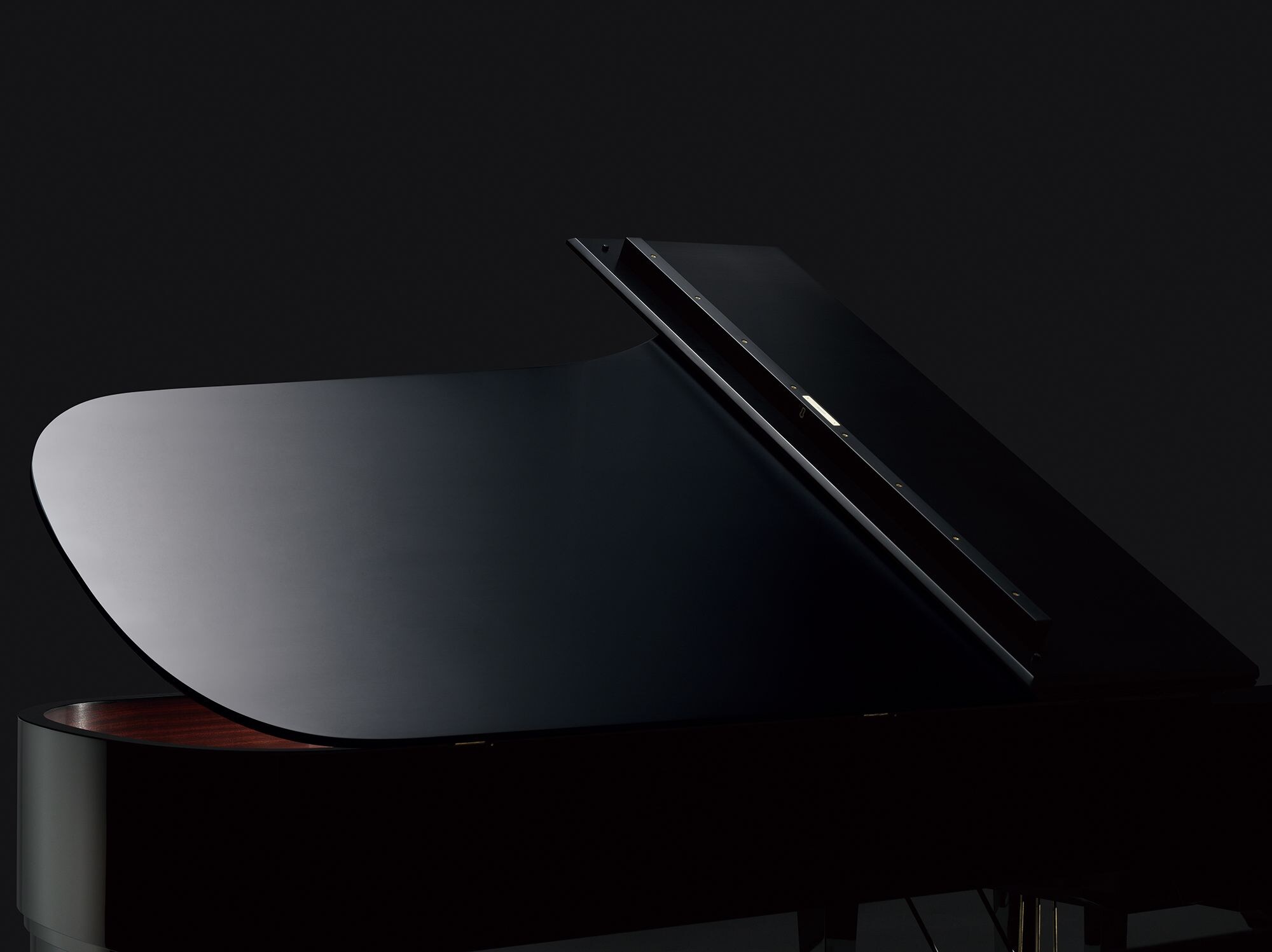Glossy black lid and body of a Yamaha CF Series grand piano
