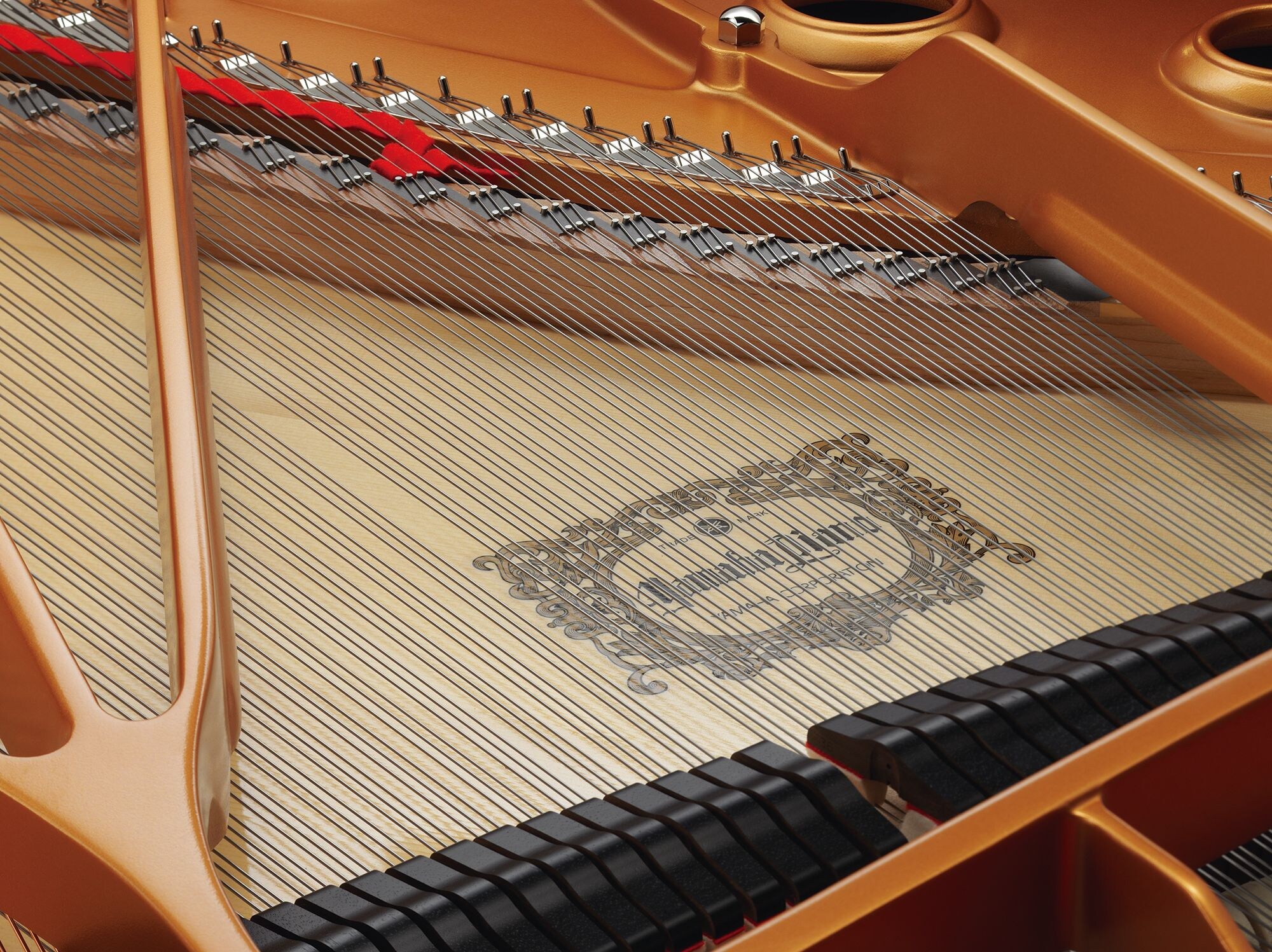 Piano wires stretched across a Yamaha grand piano soundboard
