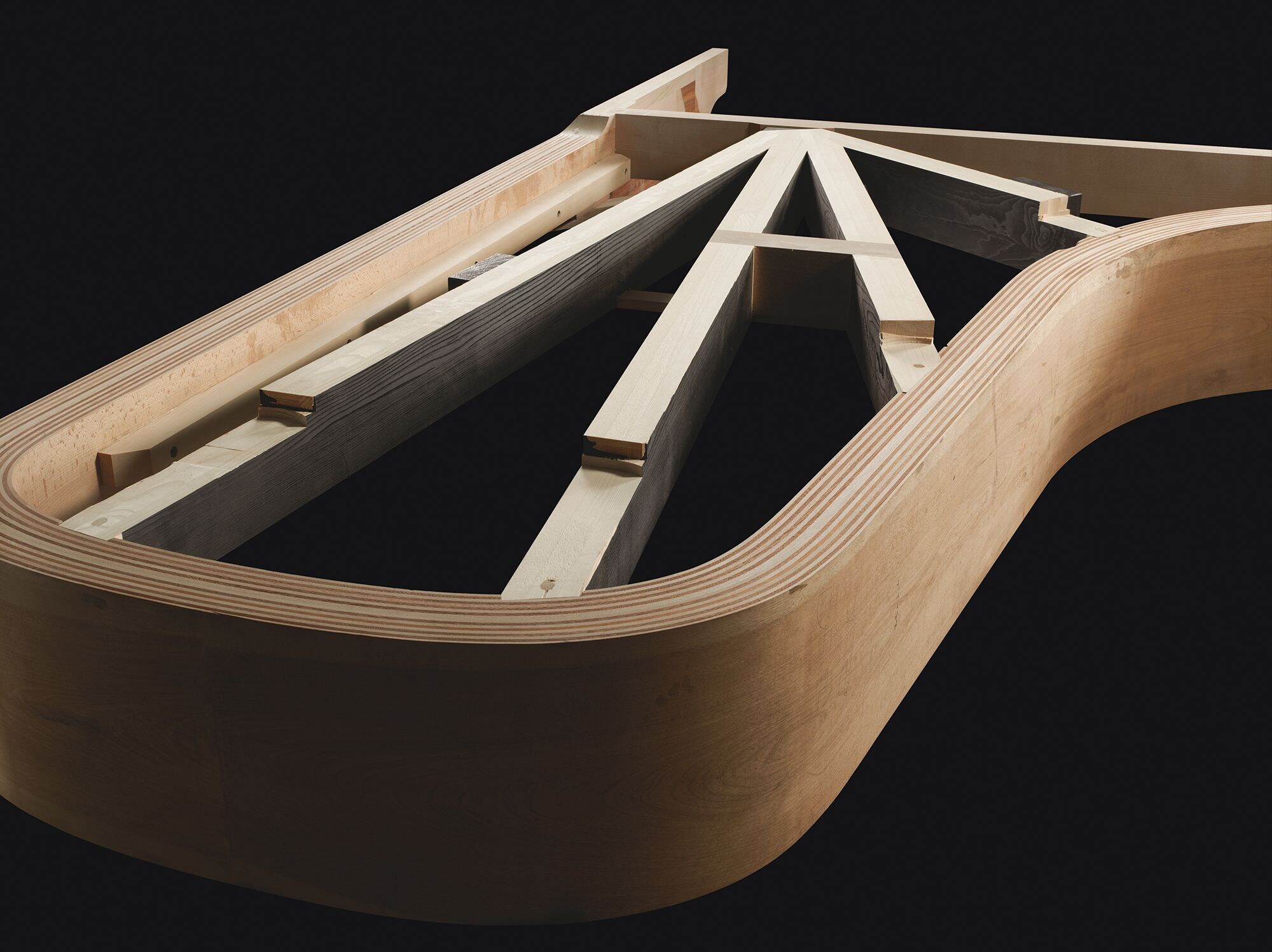 Layered wooden rim construction of a Yamaha grand piano casing