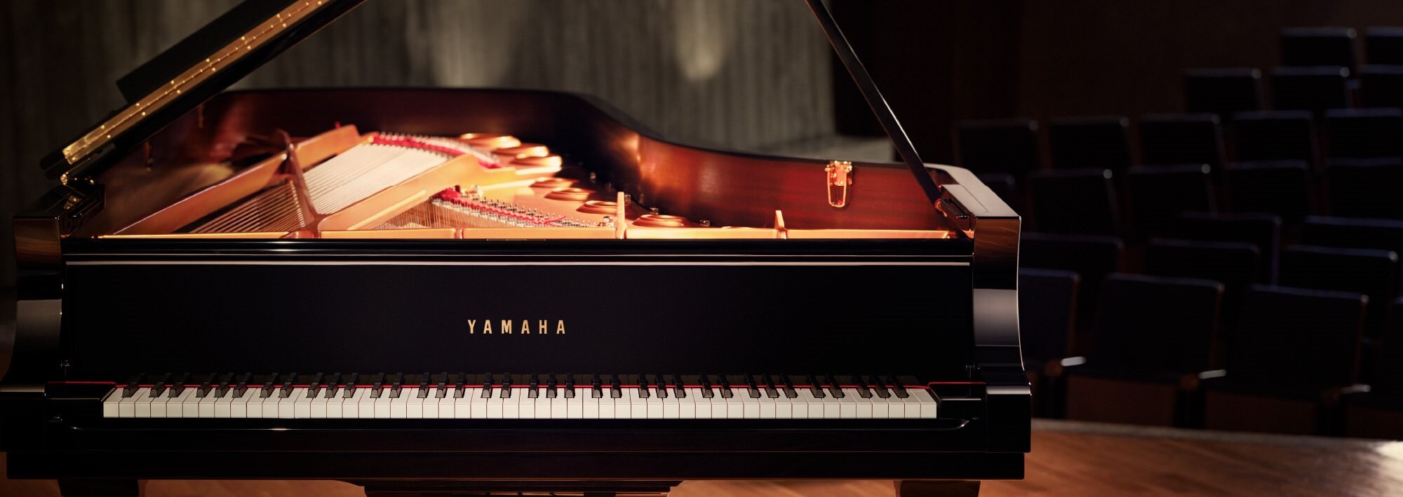 Yamaha CFX concert grand piano on a concert hall stage with its lid open