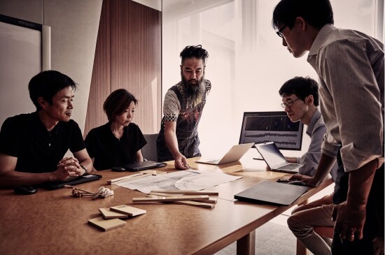 Designers and engineers shaping the Yamaha CFX around a work table