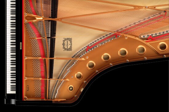 Interior of a Yamaha CFX concert grand piano showing the soundboard and frame