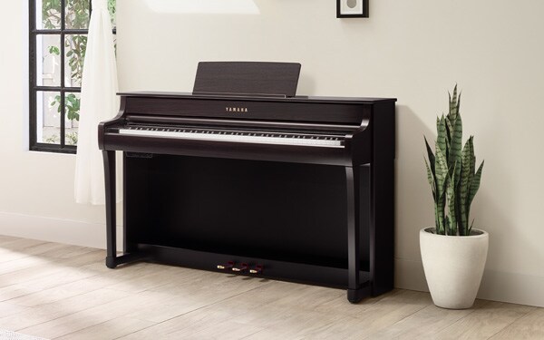 Yamaha Clavinova CLP-835 digital piano in a bright modern room.