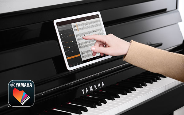 A tablet running the Yamaha Smart Pianist app on a Clavinova piano