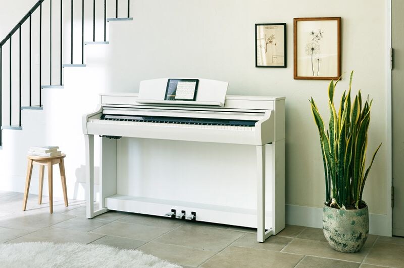 A white Yamaha CSP-255 Clavinova in a bright home interior