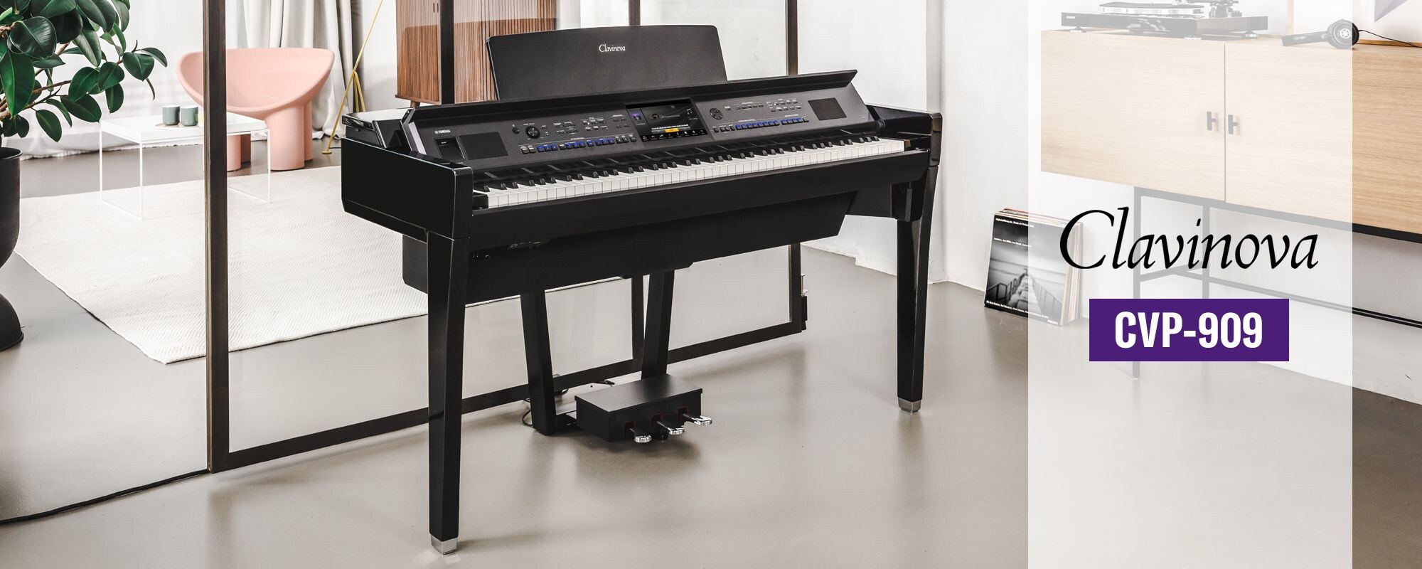 Yamaha CVP-909 Clavinova digital piano in a bright modern room.