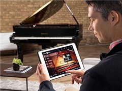 Man using a tablet to control a Yamaha Disklavier ENSPIRE CL piano