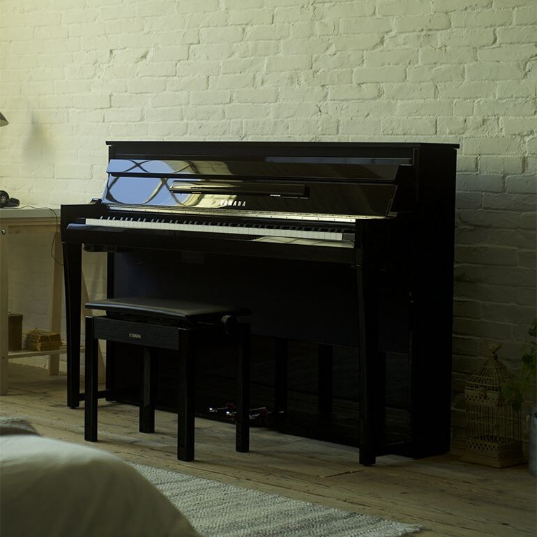 Yamaha NU1XA AvantGrand piano with matching bench in a home interior.