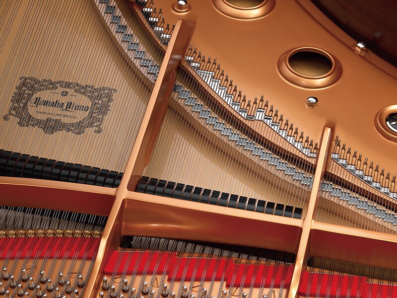 The interior of a Yamaha CFX concert grand piano.
