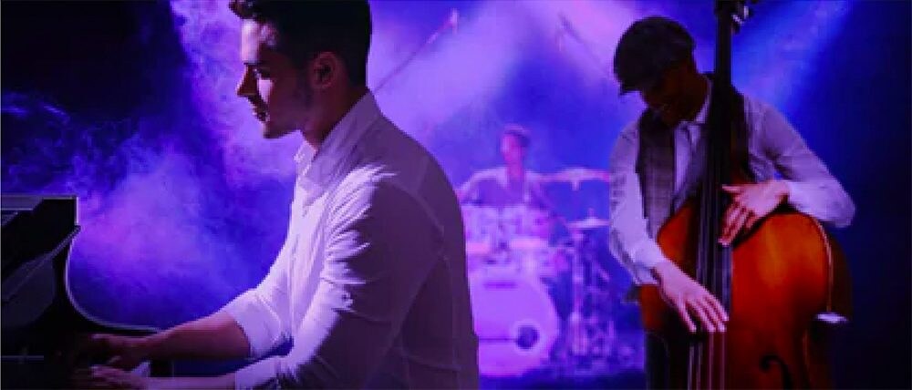 A person playing the piano with a band